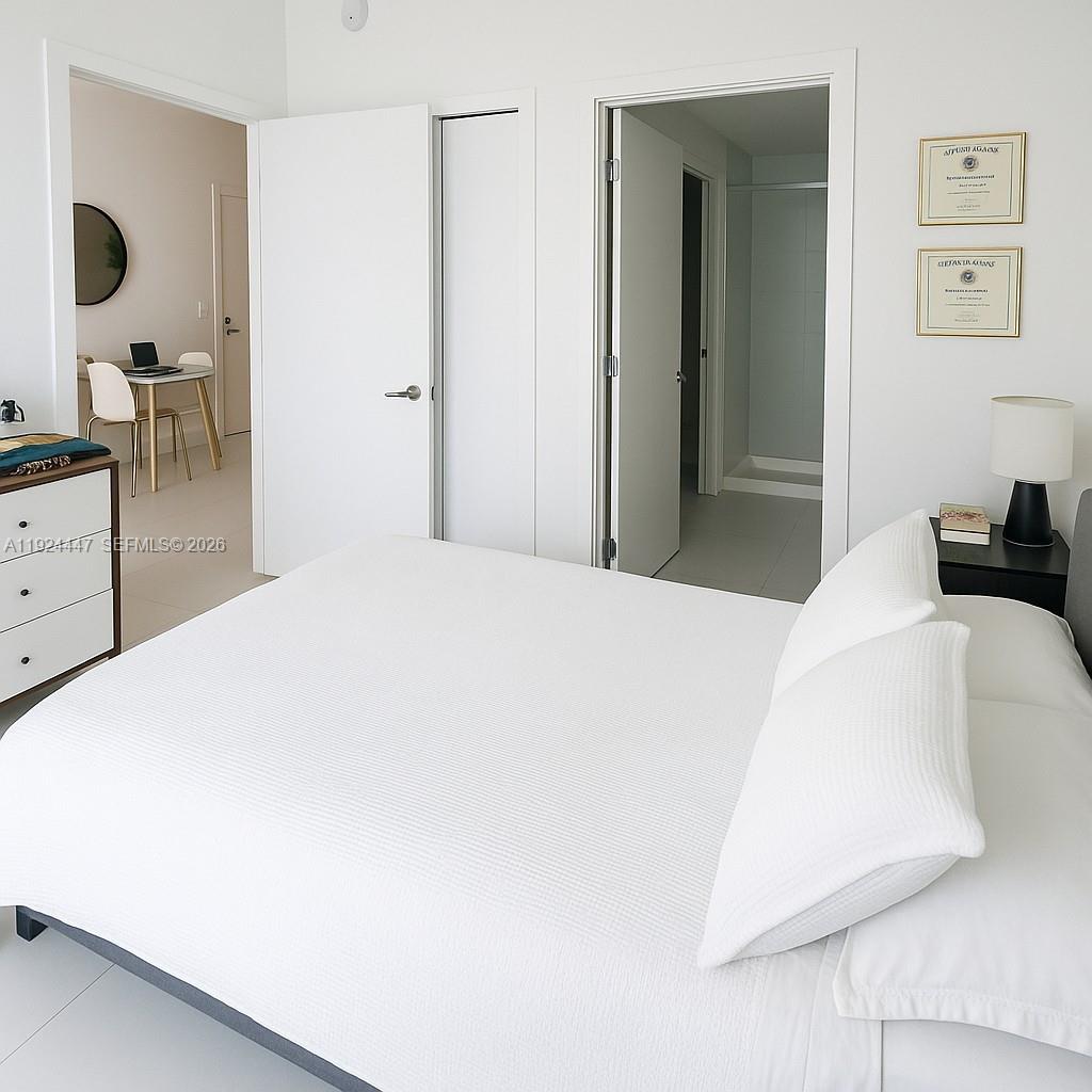 501 Northeast 31st Street, Unit 2902 Miami, FL 33137 - Photo 12 of 36 a bedroom with a bed and a dresser