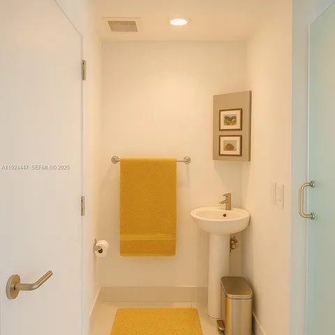 a bathroom with a sink and mirror with toilet