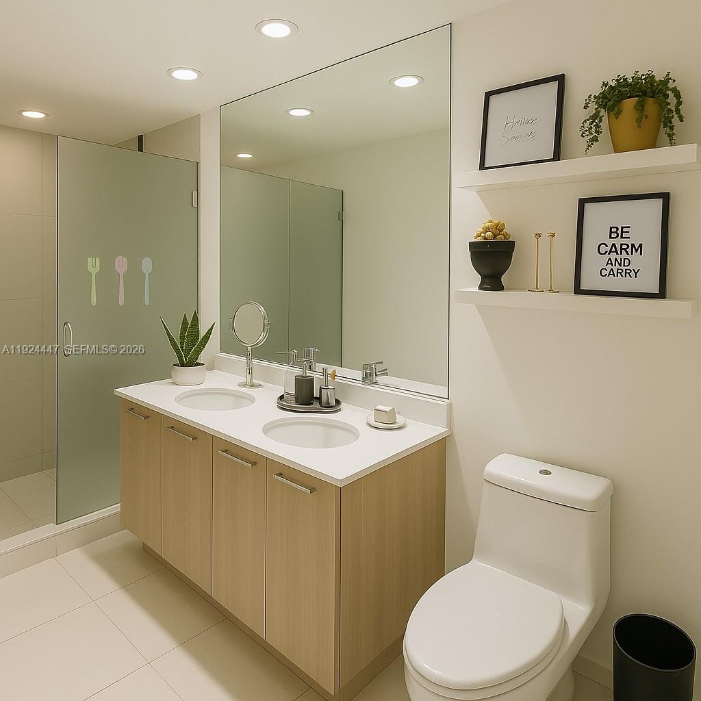 501 Northeast 31st Street, Unit 2902 Miami, FL 33137 - Photo 14 of 36 a bathroom with a toilet sink and mirror