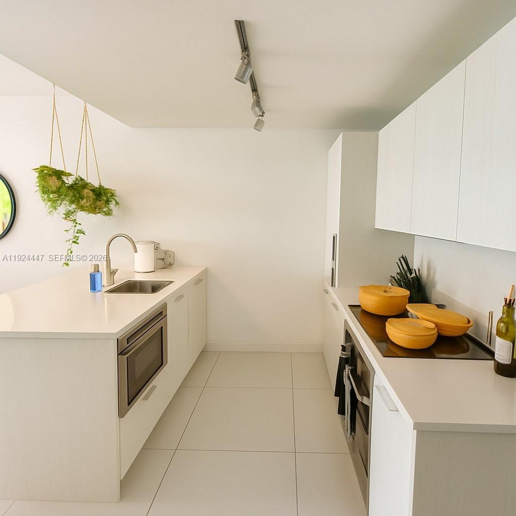 501 Northeast 31st Street, Unit 2902 Miami, FL 33137 - Photo 6 of 36 a kitchen with a sink and cabinets
