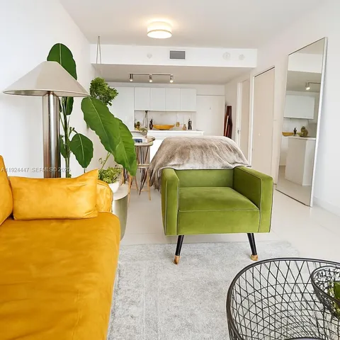 a bedroom with a bed and painting on the wall