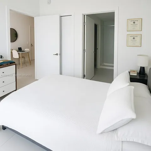 a bedroom with a bed and a dresser