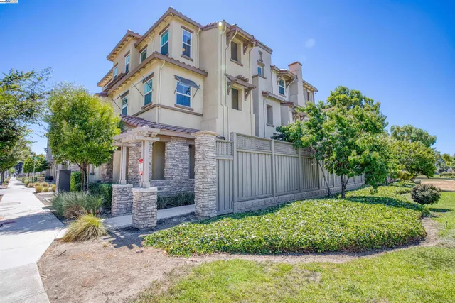 a front view of a house with a garden and plants