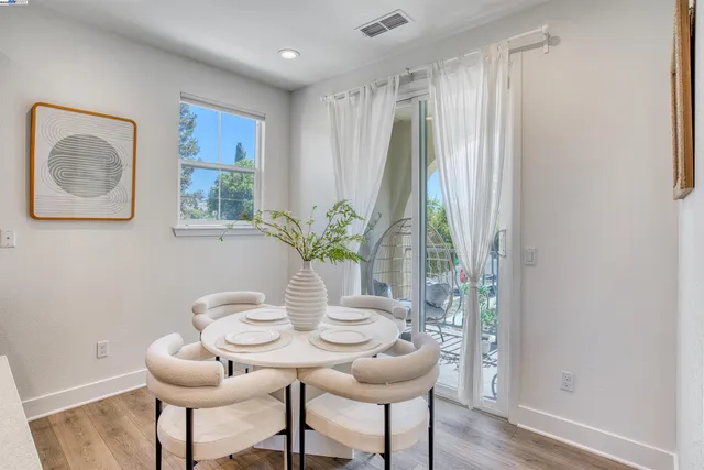 a view of a dining room with furniture window and wooden floor