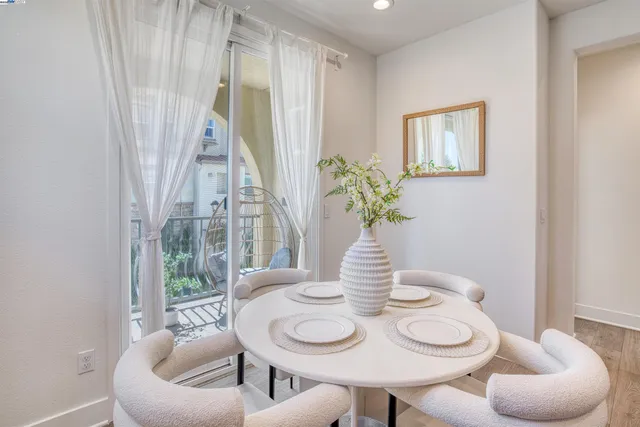 a dining room with furniture and wooden floor