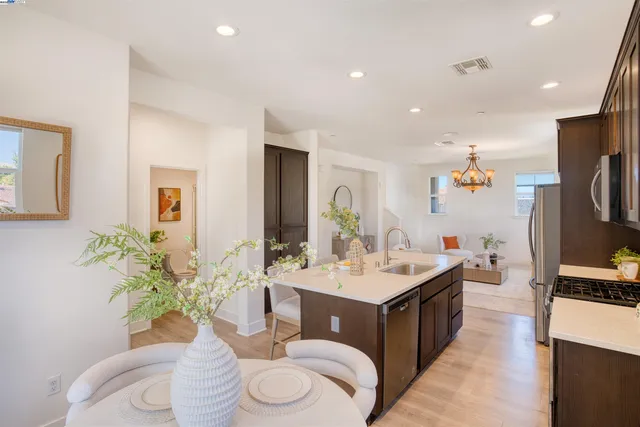 a living room with furniture a sink and a flat screen tv