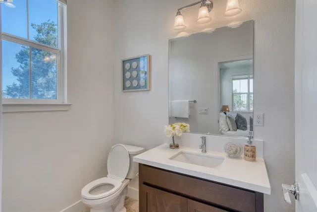 a bathroom with a toilet a sink and mirror