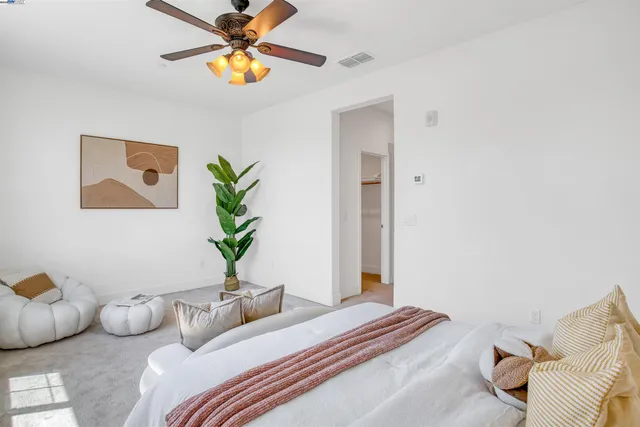 a bedroom with furniture and a potted plant
