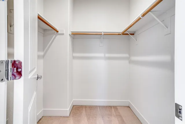 a view of walk in closet with empty racks