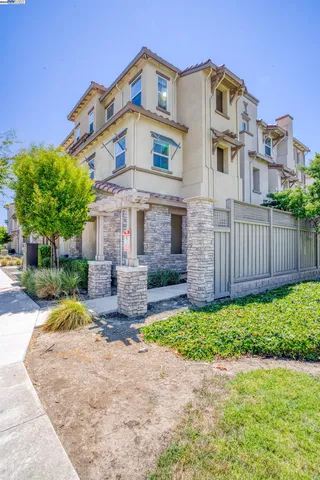 a front view of a house with a garden and yard