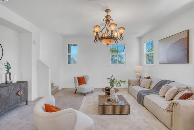 a living room with furniture a rug and a chandelier