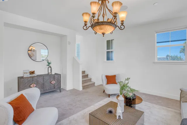 a living room with furniture and a chandelier