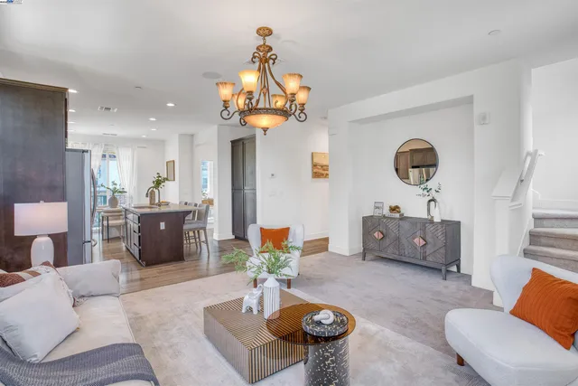 a living room with furniture and a chandelier