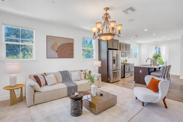 a living room with furniture a window and kitchen view