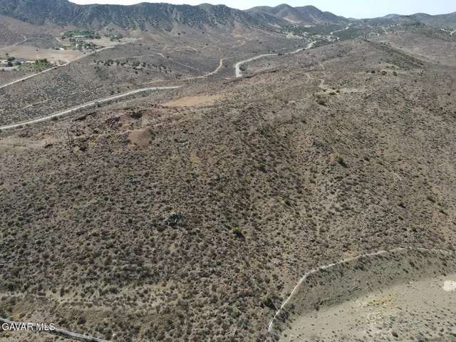 a view of a dry yard with mountains