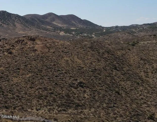 a view of a large mountains in a field