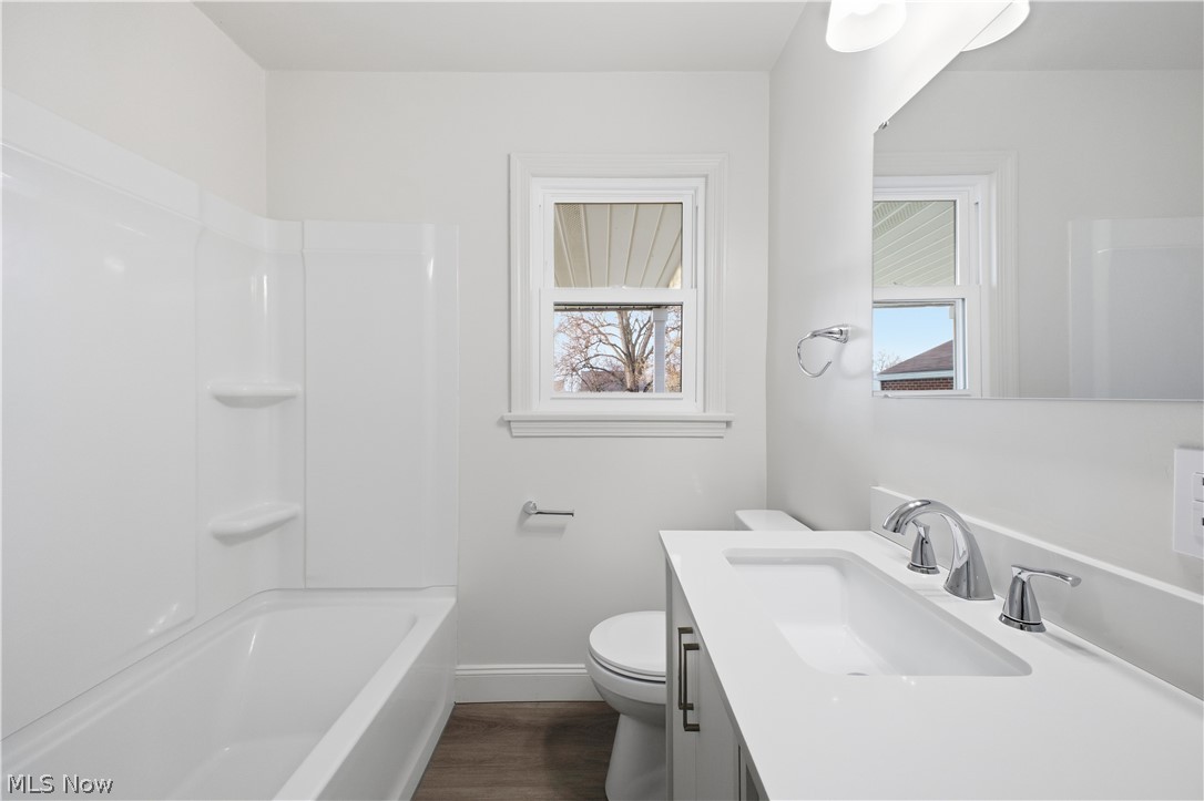 227 Wilson Street Struthers, OH 44471 - Photo 23 of 44 Bathroom featuring vanity, dark wood-style flooring, and bathtub / shower combination