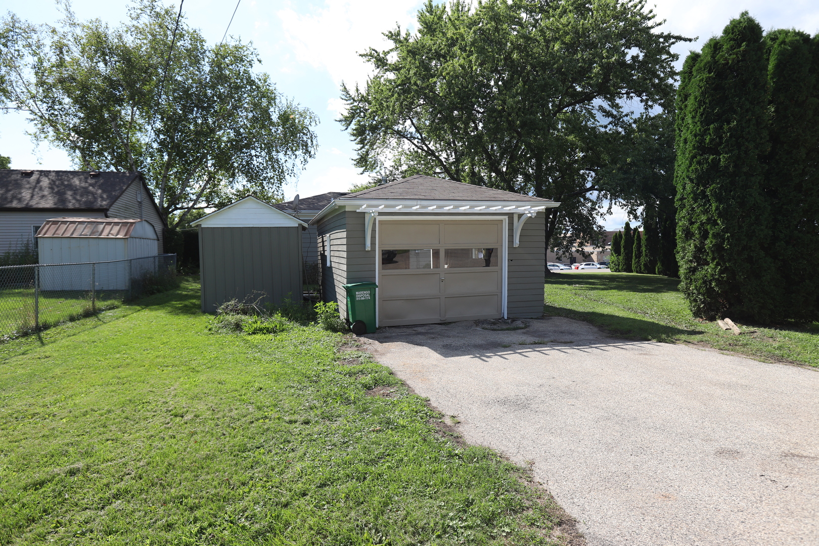 1103 Garfield Road Harvard, IL 60033 - Photo 20 of 28 a front view of a house with a yard and a garage