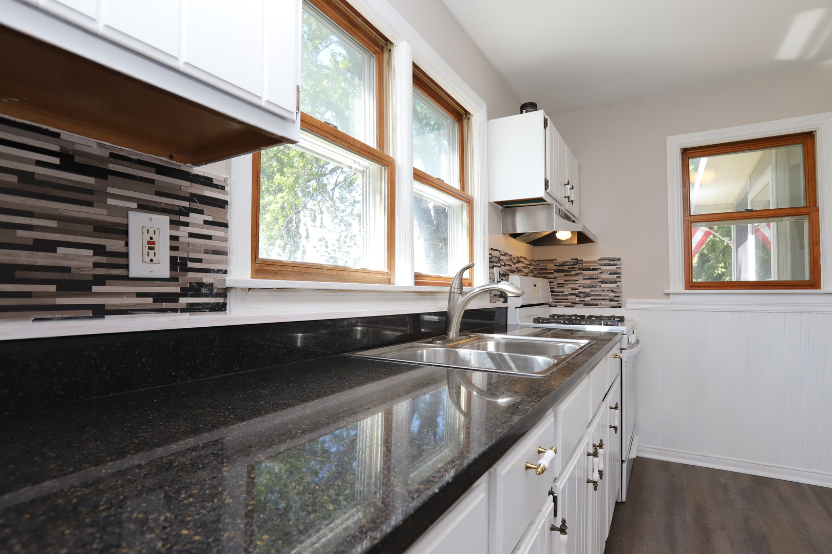 1103 Garfield Road Harvard, IL 60033 - Photo 3 of 28 a kitchen that has a sink and a stove