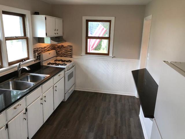1103 Garfield Road Harvard, IL 60033 - Photo 4 of 28 a kitchen with a sink and wooden floor