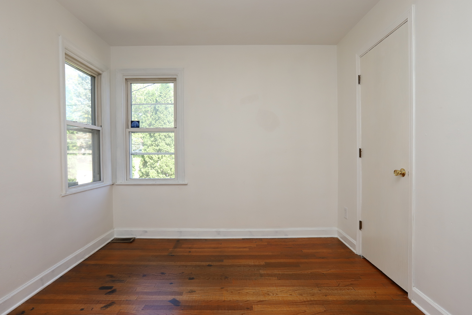 1103 Garfield Road Harvard, IL 60033 - Photo 7 of 28 a view of an empty room with wooden floor and a window