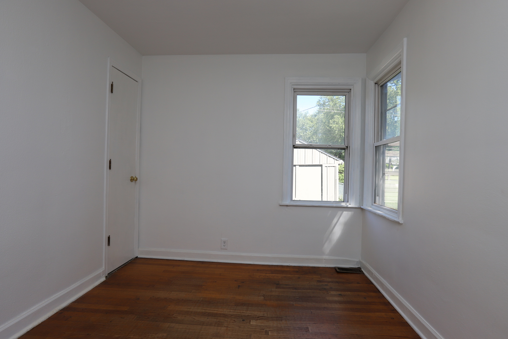1103 Garfield Road Harvard, IL 60033 - Photo 8 of 28 a view of an empty room with wooden floor and a window