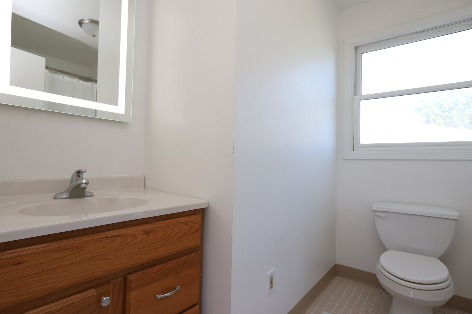 1103 Garfield Road Harvard, IL 60033 - Photo 9 of 28 a bathroom with a toilet sink and mirror