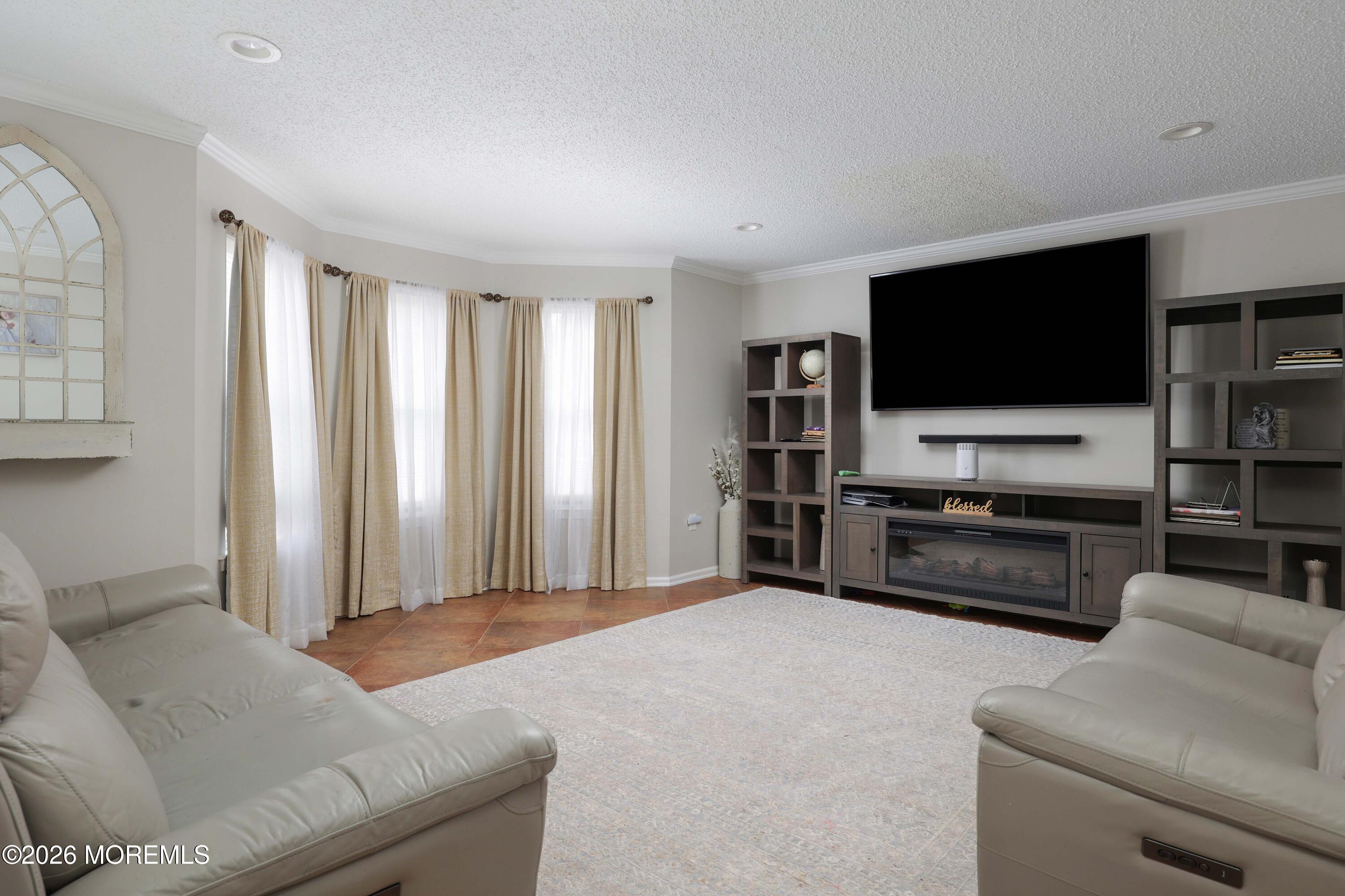 80 West Shenendoah Road Howell, NJ 07731 - Photo 11 of 34 a living room with furniture and a flat screen tv