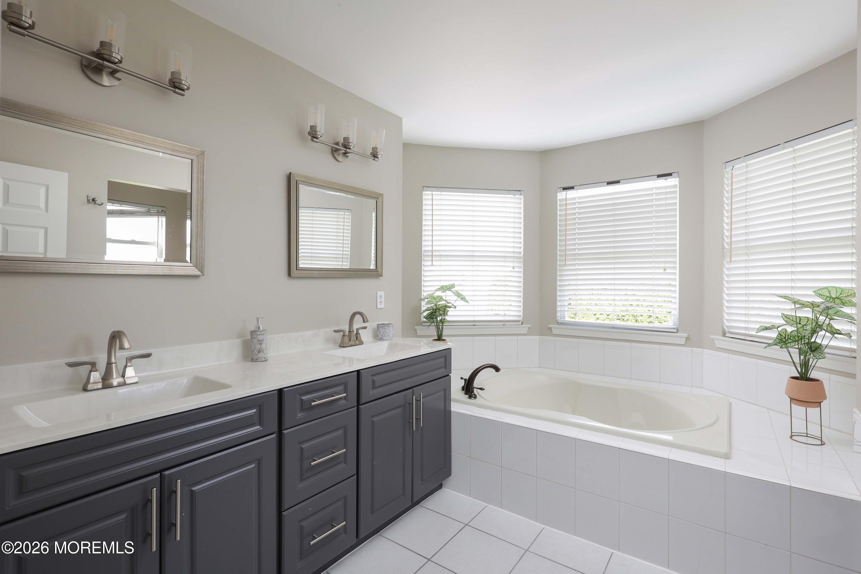 80 West Shenendoah Road Howell, NJ 07731 - Photo 19 of 34 a bathroom with a tub sink and mirror