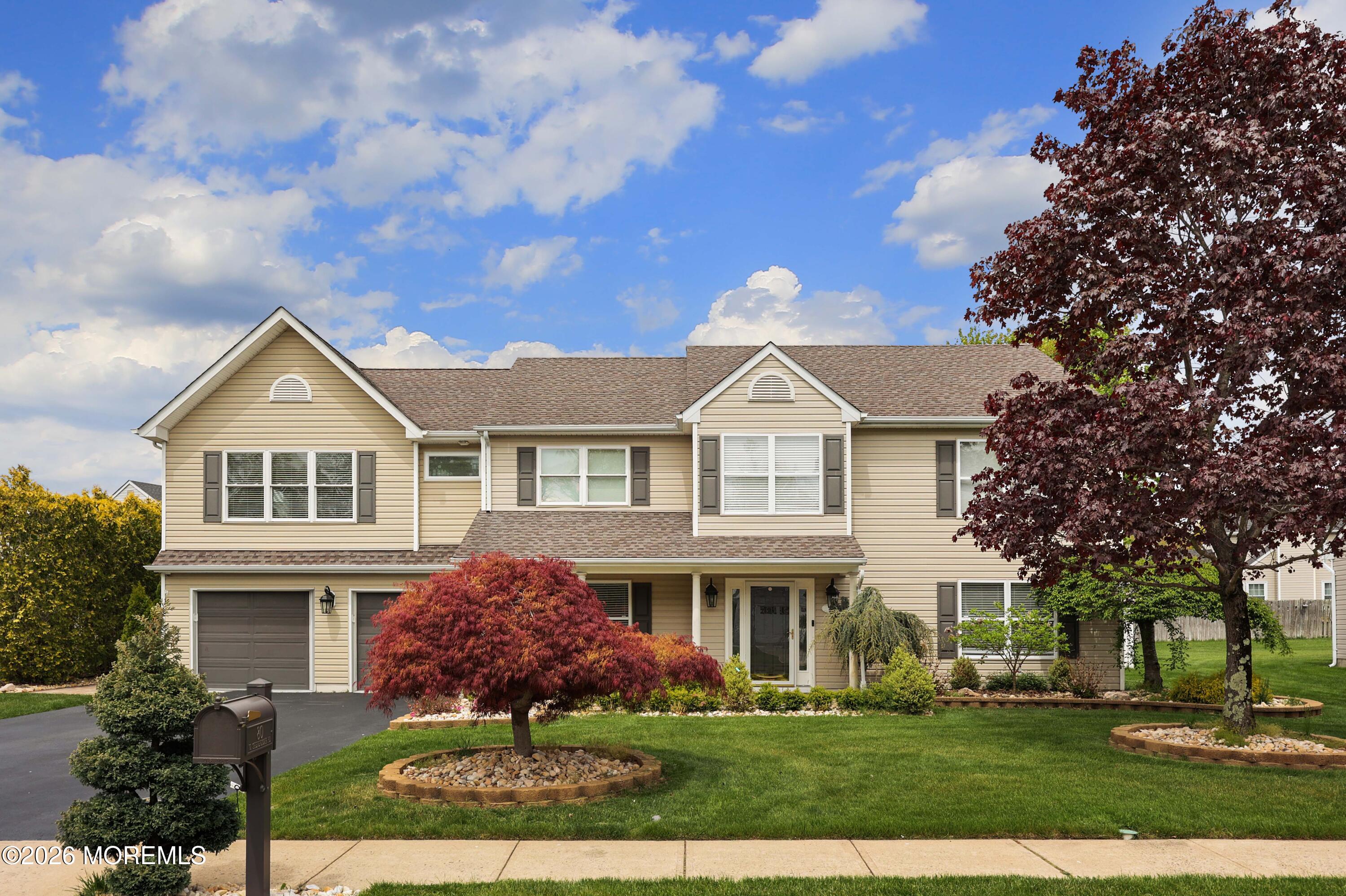 80 West Shenendoah Road Howell, NJ 07731 - Photo 2 of 34 a front view of a house with a garden
