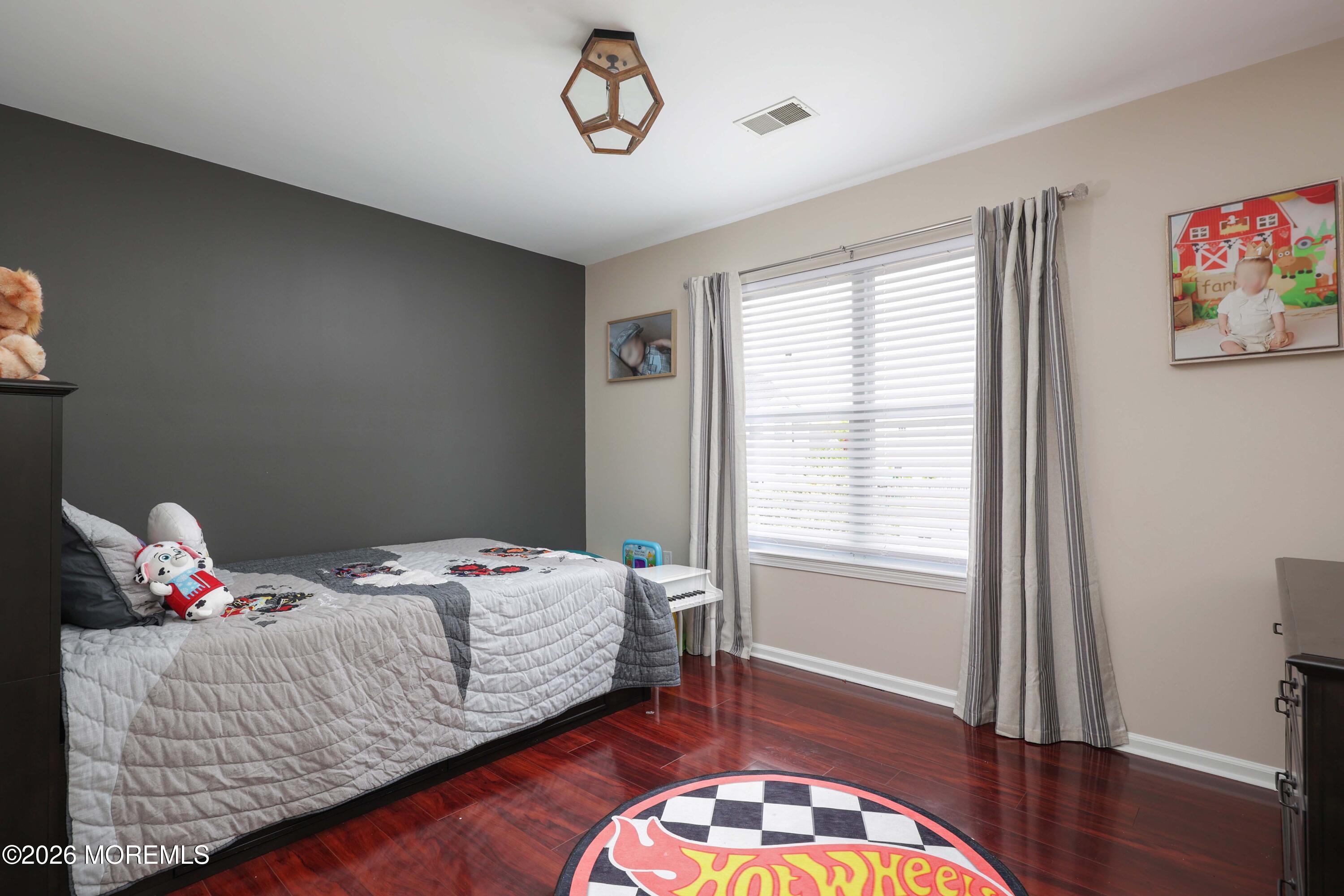 80 West Shenendoah Road Howell, NJ 07731 - Photo 21 of 34 a bedroom with a bed and wooden floor