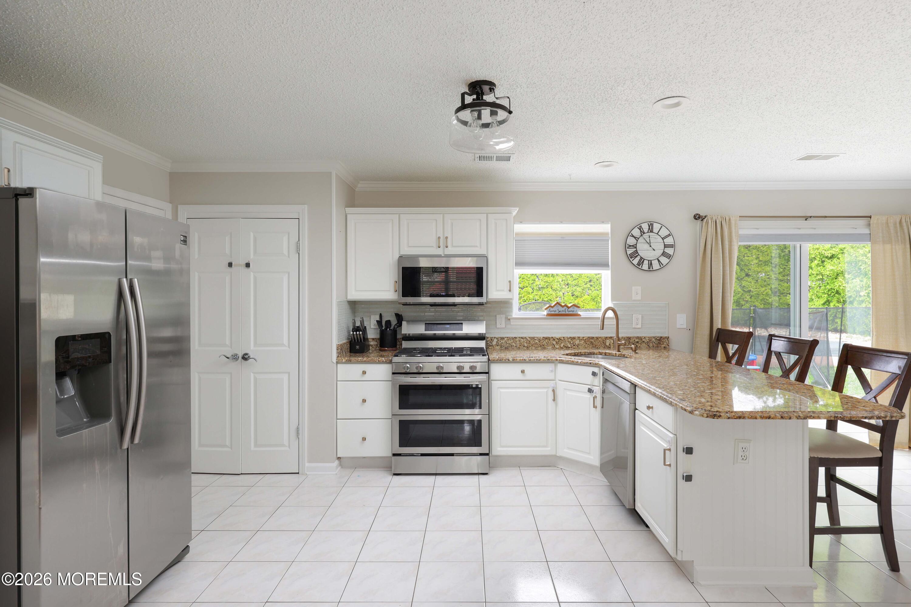 80 West Shenendoah Road Howell, NJ 07731 - Photo 5 of 34 a kitchen with stainless steel appliances granite countertop a refrigerator and a stove top oven