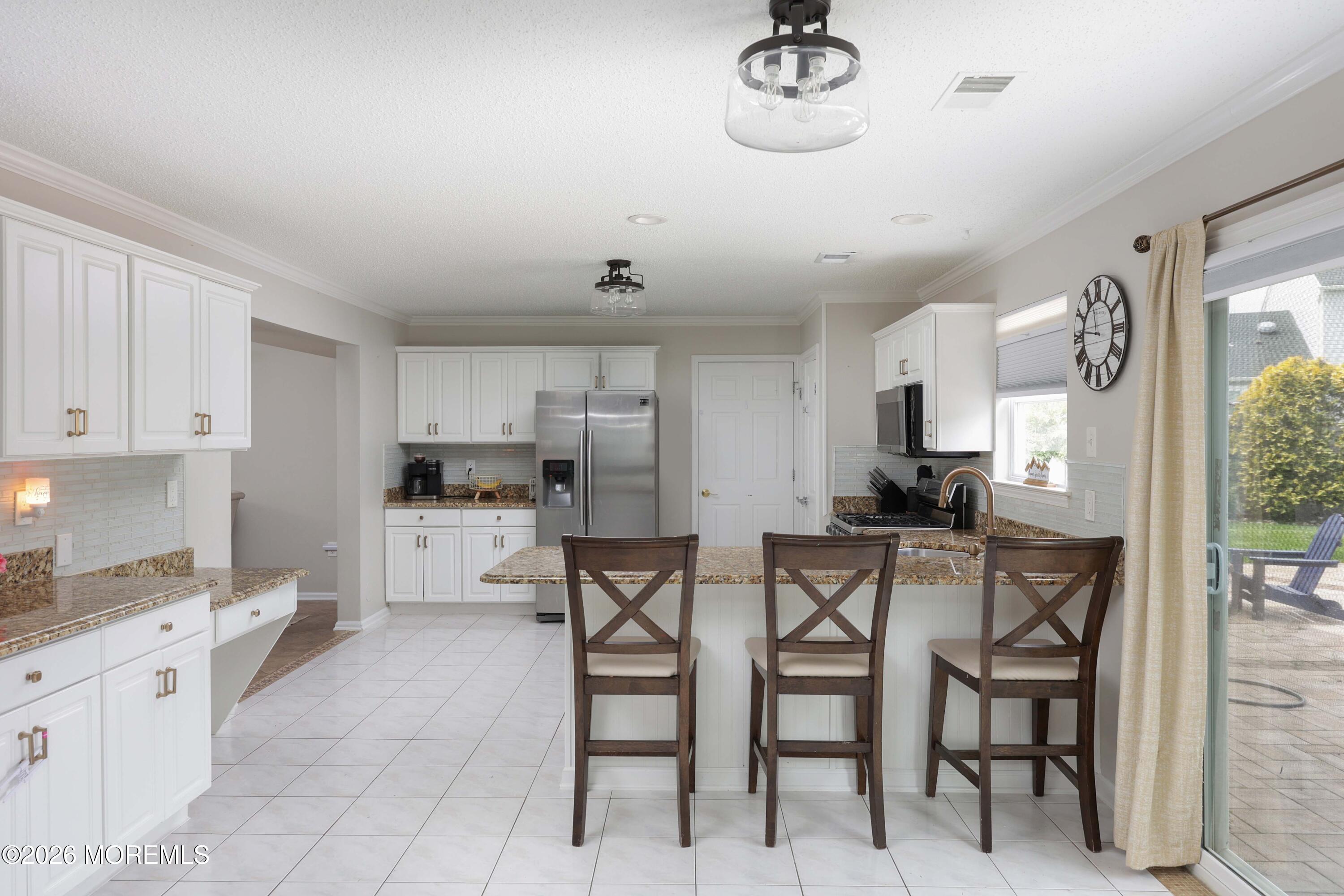80 West Shenendoah Road Howell, NJ 07731 - Photo 6 of 34 a kitchen with cabinets and chairs
