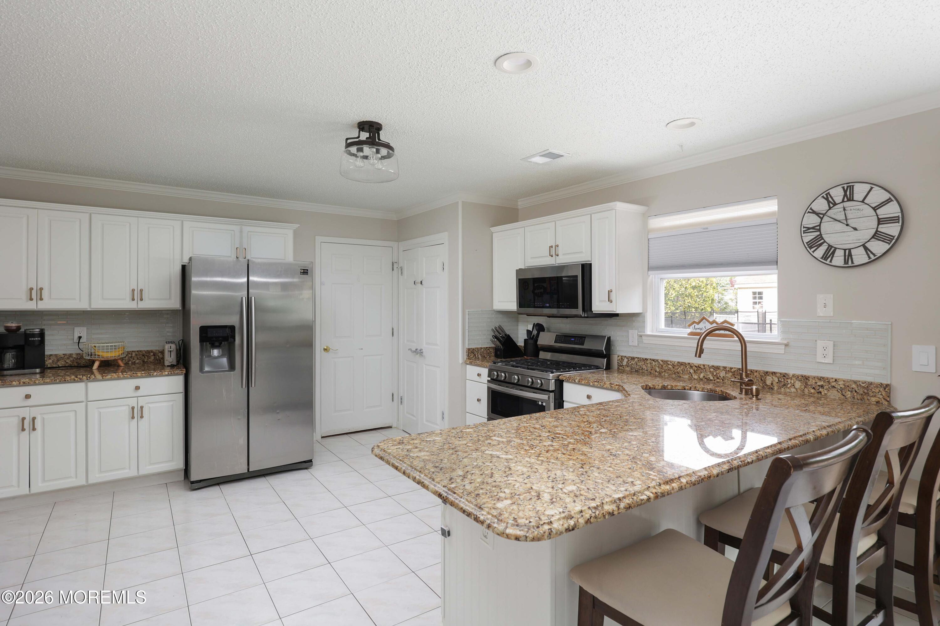 80 West Shenendoah Road Howell, NJ 07731 - Photo 8 of 34 a kitchen with stainless steel appliances granite countertop a sink refrigerator and microwave
