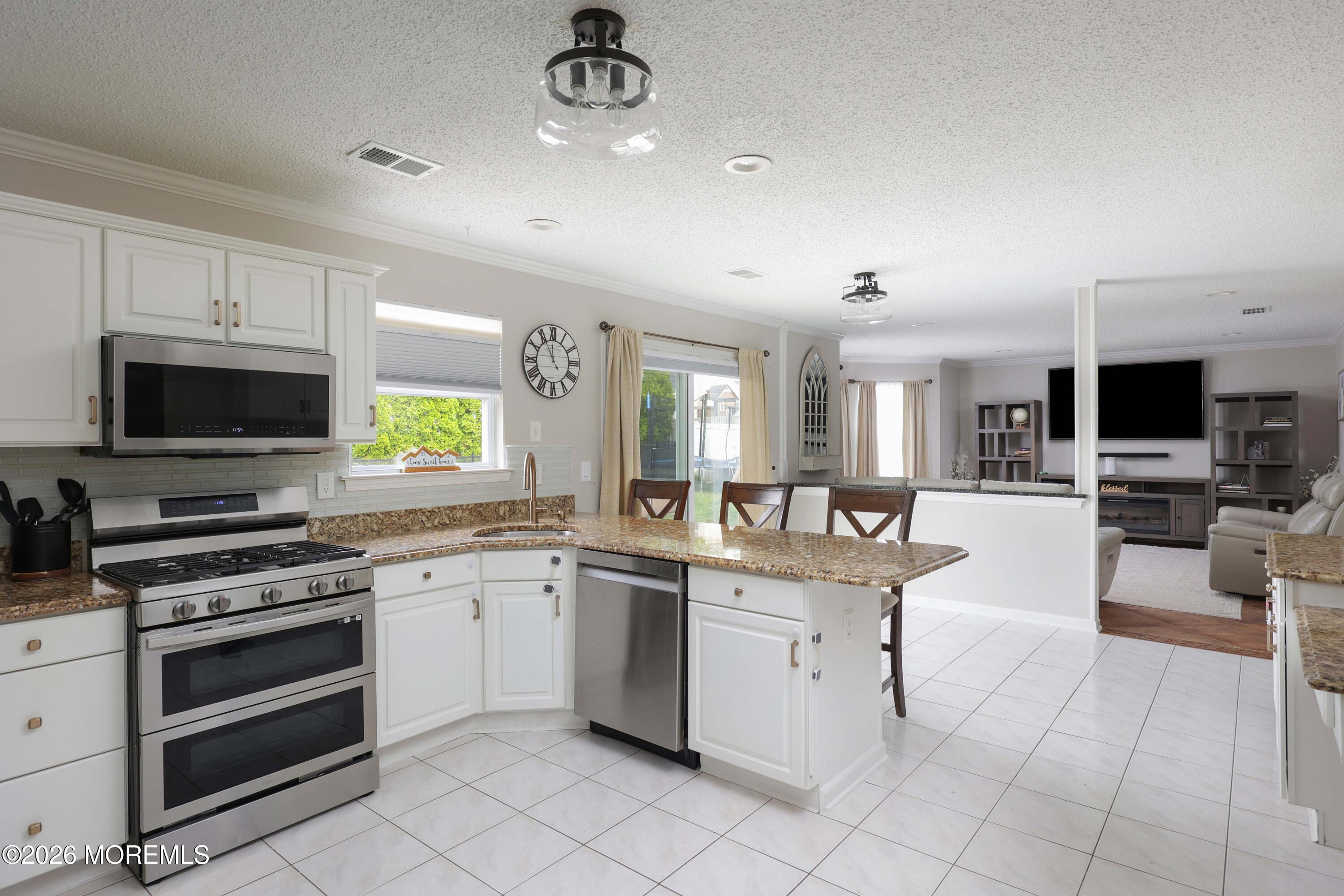 80 West Shenendoah Road Howell, NJ 07731 - Photo 9 of 34 a kitchen with white cabinets and appliances