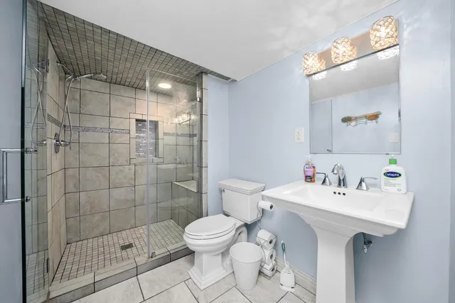 a bathroom with a sink toilet and shower