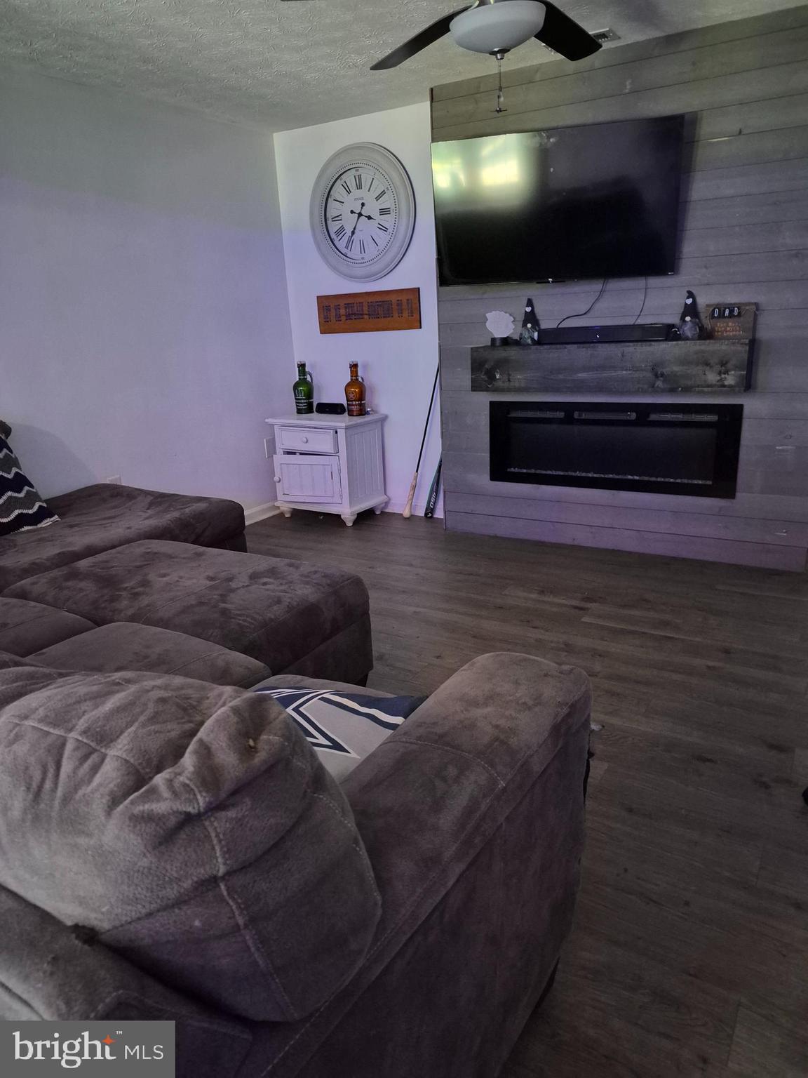 1440 Drummer Hill Road Front Royal, VA 22630 - Photo 29 of 42 a living room with furniture and a flat screen tv