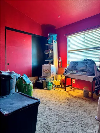 a bedroom with bed and a mirror