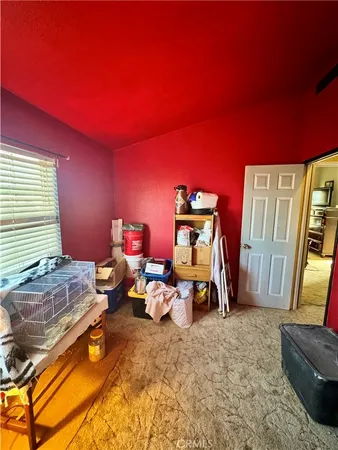 a bedroom with a bed and flat screen tv
