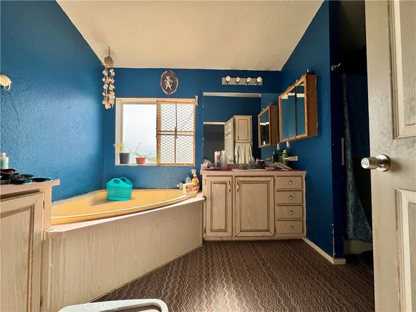 a bathroom with a tub and a shower