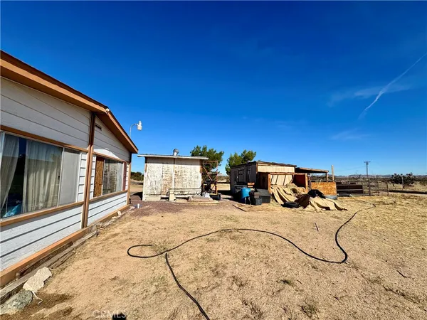 a view of a backyard of the house