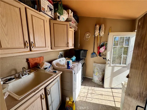 a bedroom with furniture and a large window