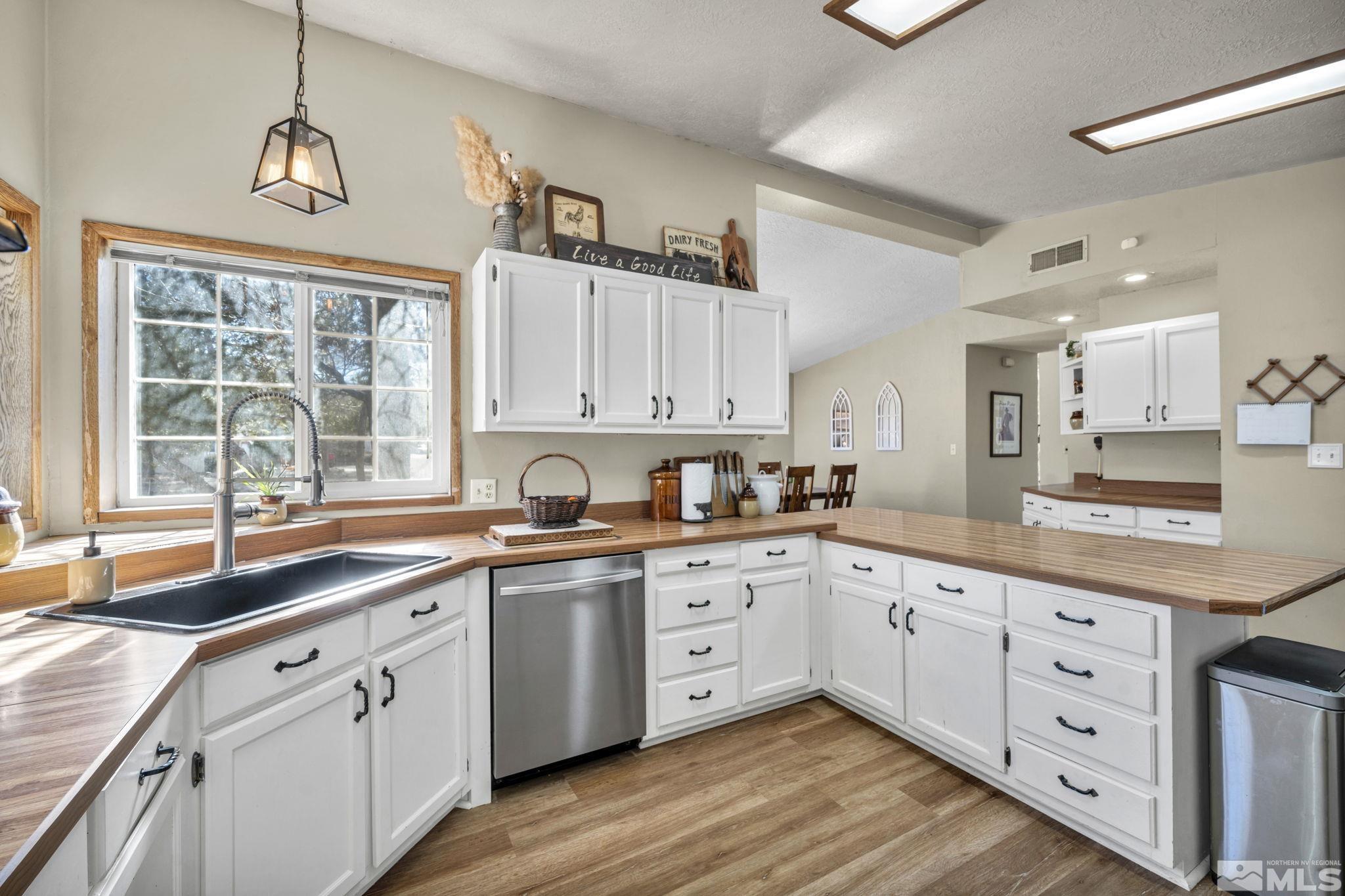 17345 Sunbird Lane Reno, NV 89508 - Photo 13 of 40 a large kitchen with cabinets and wooden floor
