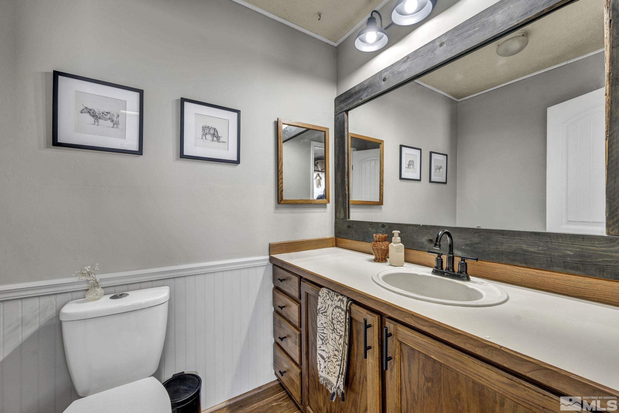 17345 Sunbird Lane Reno, NV 89508 - Photo 15 of 40 a bathroom with a toilet sink and mirror