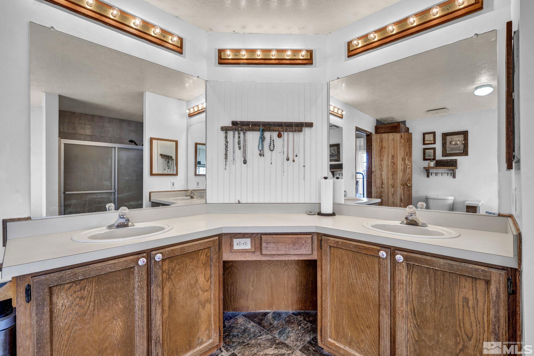 17345 Sunbird Lane Reno, NV 89508 - Photo 20 of 40 a bathroom with a sink double vanity granite and a mirror