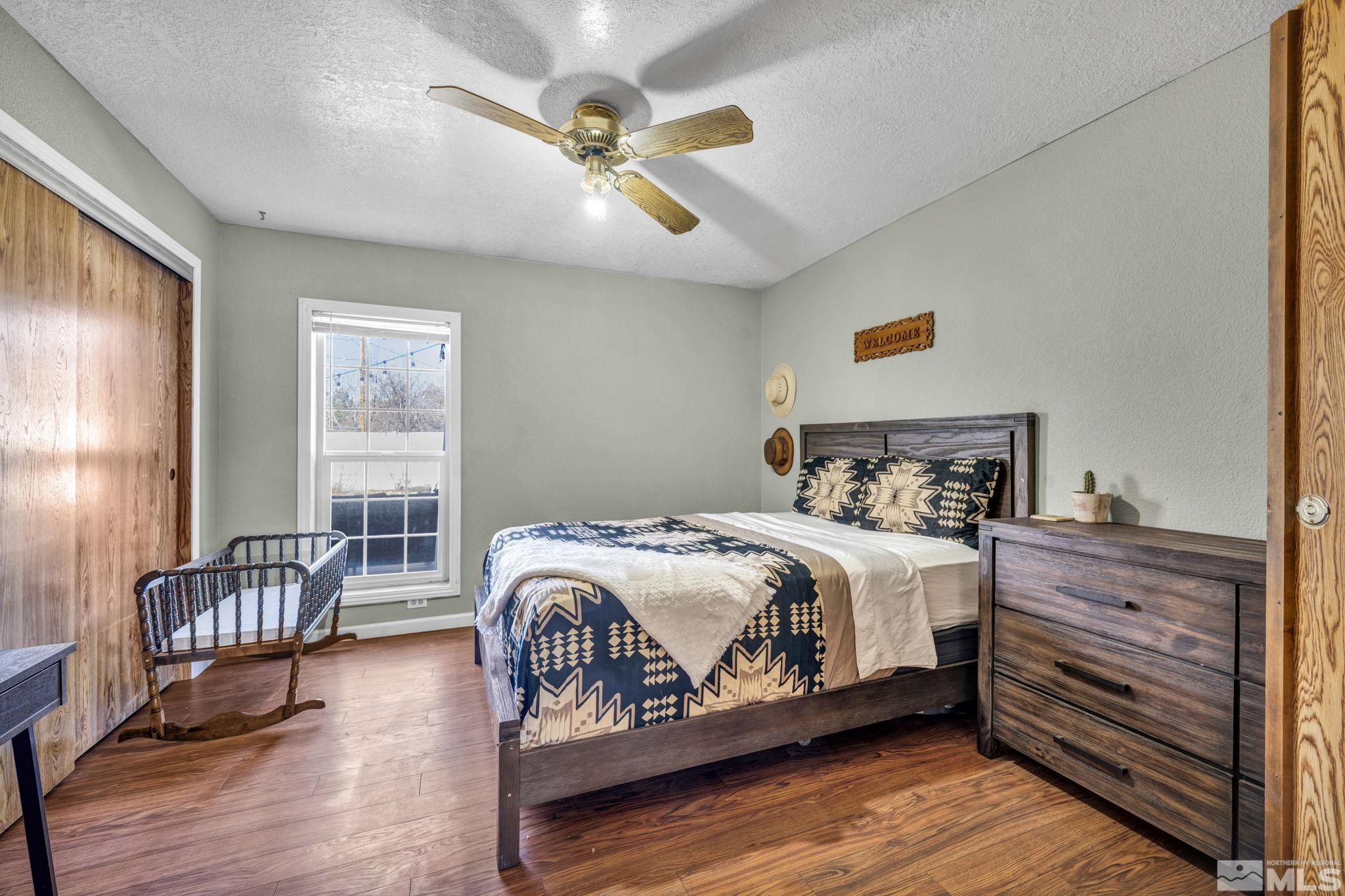 17345 Sunbird Lane Reno, NV 89508 - Photo 25 of 40 a bedroom with a bed and wooden floor