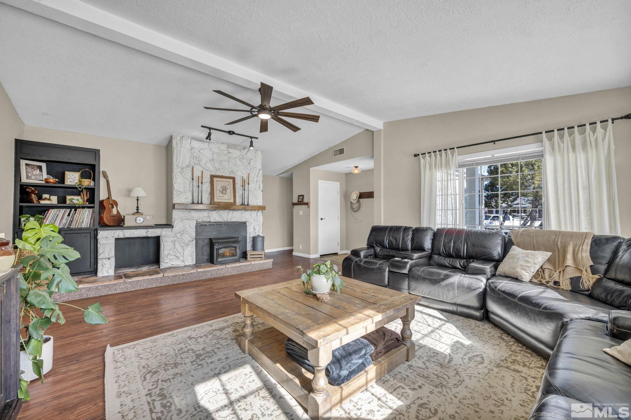 17345 Sunbird Lane Reno, NV 89508 - Photo 7 of 40 a living room with furniture a fireplace and a window