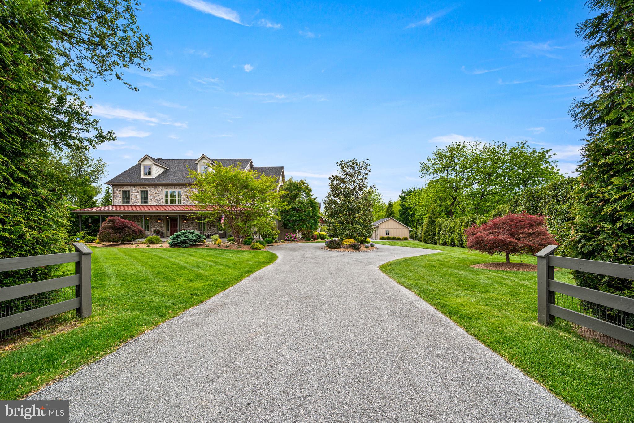 1548 Morstein Road Malvern, PA 19355 - Photo 2 of 80 a view of a big house with a big yard and potted plants and large tree