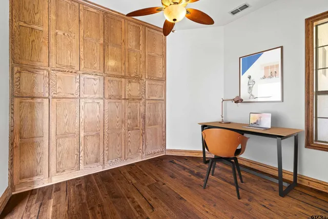 an aerial view of a house with a yard and garden