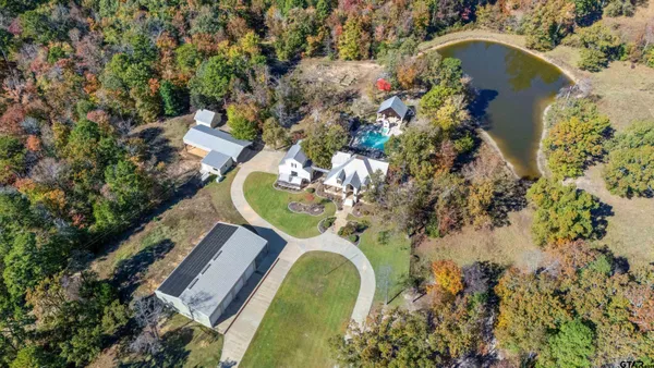 an aerial view of a house with a swimming pool